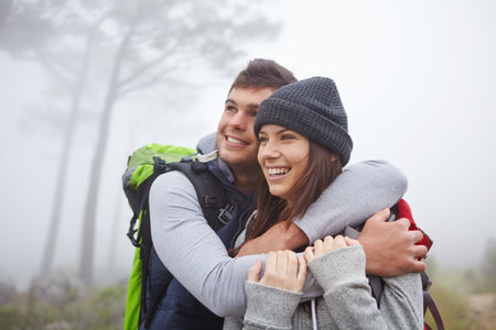 Hiking, hug and travel with couple in nature for trekking adventure, honeymoon getaway and support. Sightseeing, backpacking and tourism with man and woman outdoor for bonding, commitment and loveの写真素材