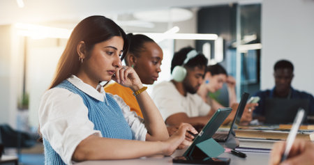 Startup, coworking and people on tech for project, research and seo report for website traffic. Creative agency, team and workers on tablet in office for digital marketing, online review and planningの写真素材