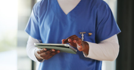 Person, hands and nurse with tablet in hospital for email, research or telehealth report. Technology, scroll and medical worker with healthcare assessment, review results and wellness info in clinicの写真素材
