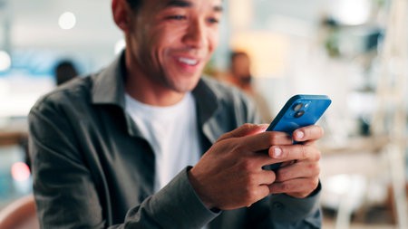 Media agency, internet and happy man in office, cellphone and typing with website campaign. Person, network or journalist with smartphone, online chatting or email for schedule and message to contactの写真素材