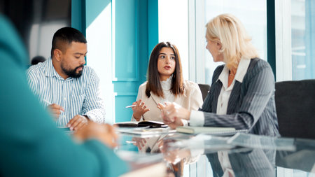 Review, meeting or people in office with notes, collaboration or market research. Teamwork, talk or creative director in agency with book, plan or feedback for business.の写真素材