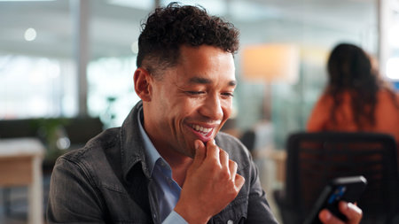 Phone, laugh and businessman in office with networking, communication or social media on mobile app. Smile, technology and male person with cellphone for contact, email or texting in workplace.の写真素材