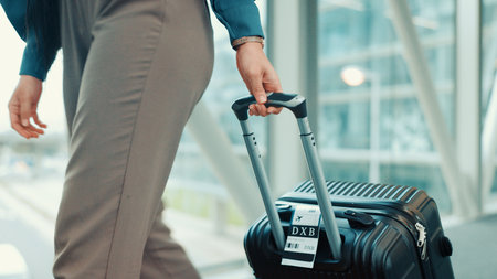 Person, hands or travel with suitcase in airport for business journey, work trip or commute. Closeup, employee or traveler with luggage for international boarding, corporate visit or job opportunityの写真素材