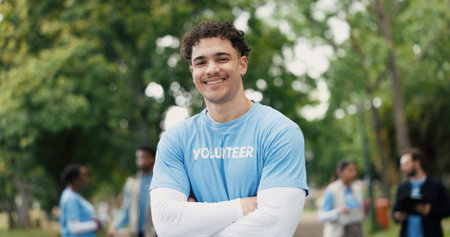 Happy man, portrait and volunteer with confidence for eco friendly development or change in nature. Male person, activist or NGO with smile or arms crossed for charity, community work or donationの写真素材