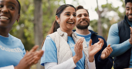 Applause, smile and volunteer people outdoor for food drive celebration, motivation or success. Clapping, donation and support with excited friends in park together for charity or community outreachの写真素材