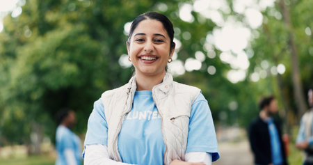 Portrait, woman and volunteer with smile at park for community service, charity outreach and ngo. Happy, female person or earth day project for environment cleanup, social responsibility and about usの写真素材