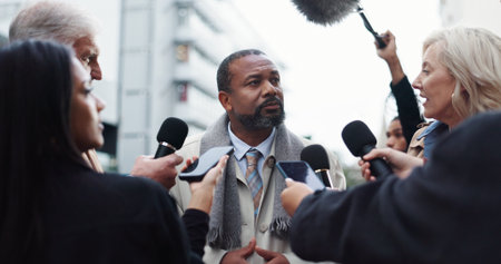 Politician, man and interview with journalist for election announcement, campaign opinion or reaction. Political leader, people and media in city for qna discussion, question and mayor vote feedback.の写真素材