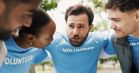 Volunteer, man and group in huddle outdoor for community service, NGO and help for social...