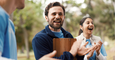 Applause, clipboard and volunteer people outdoor for food drive celebration, motivation or success. Clapping, schedule and support with excited friends in park for charity or community outreachの写真素材