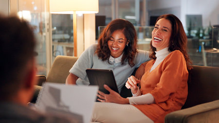 Business women, laughing and meeting with tablet in office, project management or pitch agenda document. Talk, colleagues and tech with schedule or funny team for online task planning in workplaceの写真素材