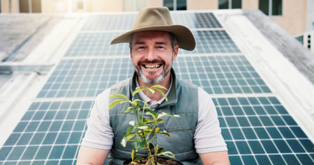 Portrait, man outdoor or solar panel with plant for clean energy, farming and eco friendly project. Person, farmer or smile with photovoltaic system for sustainability, agriculture or natural growth.の写真素材