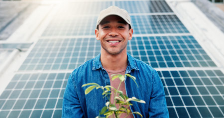 Man, plant and portrait at solar panel for clean energy, alternative power and go green initiative. Farmer, smile and outdoor at photovoltaic grid for crop growth, sustainability and responsibilityの写真素材