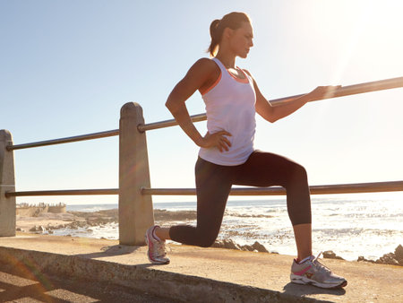 Beach, fitness and woman with routine, lunge and endurance with workout. Seaside, healthy person and...