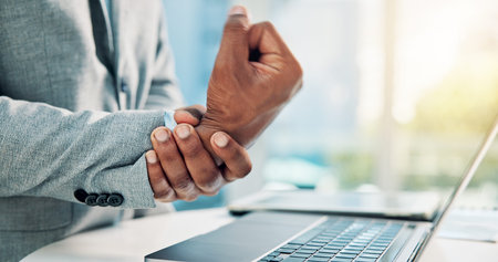 Corporate man, hands and wrist pain in office with laptop from arthritis, carpal tunnel and sprain....