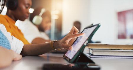 Tablet, hands and student in college for learning, course research or scroll for knowledge. Tech, university and woman in classroom for studying, assignment info or test preparation for educationの写真素材