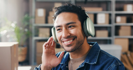 Supply chain, headphones and man with smile, startup or listening to music, sound or podcast. Business owner, entrepreneur or person with happiness, distribution or radio with audio tech or logisticsの写真素材