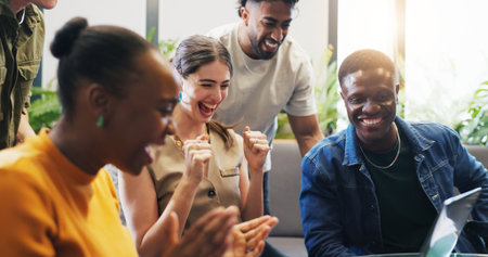 Business people, laptop and fist pump with celebration, teamwork and success for project funding approval. Staff, group and employees with tech, opportunity and promotion email with clapping handsの写真素材
