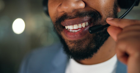 Call center, consultant and mouth of man in office for security, emergency hotline and night. Virtual advisor, dispatch operator and alarm verification specialist with person and overtime bokehの写真素材