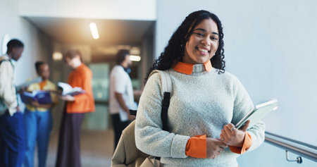 Woman, student and portrait with tablet at college, confidence and pride for scholarship at campus. Girl, happy and tech with backpack, application or education for learning development at universityの写真素材