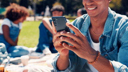 University students, outdoor and man with cellphone, hands and social media with online joke. Campus, college and person with smartphone, communication and digital app for chatting and test resultsの写真素材