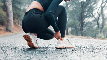 Hands, woman and ankle pain from fitness outdoor, sports injury and muscle cramp. Athlete, female runner and discomfort from exercise mistake, joint inflammation and calf strain for training accidentの写真素材