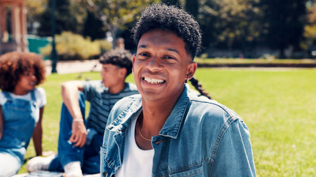 Man, student and relax with portrait outdoor for education, group study and break from learning. Smile, male person and rest with university friends, scholarship and happiness for knowledge at parkの写真素材
