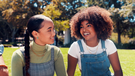 College students, park and friends talk, laugh and bonding together with scholarship story. University campus, funny women and conversation for education feedback, joke and happy girls outdoorの写真素材