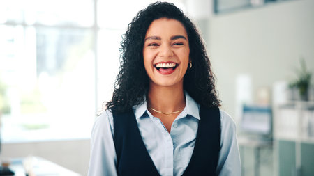 Funny and portrait of business woman in office for career, job satisfaction or opportunity. Confident and proud with employee laughing in workplace for professional developmentの写真素材