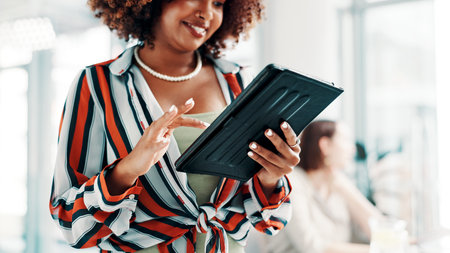 Fashion design, hands and tablet with woman in office to search clothing trends for market research. App, scroll and style inspiration with happy designer in creative workplace for apparel businessの写真素材