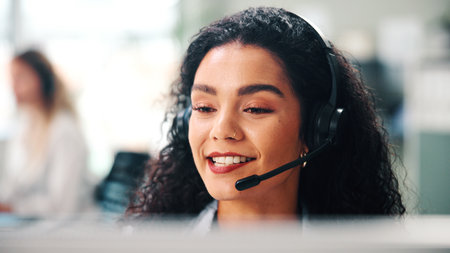 Call center, headset and woman in office, speaking and help desk with consultation. Happy person, employee and agent in workplace, system solution or contact us with customer support, talking and crmの写真素材