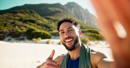 Man, selfie and fitness at beach with smile, thumbs up and portrait with break, sign and memory in summer. Person, happy and influencer with photography, profile picture or social mediaの写真素材