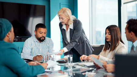 Review, meeting or people in office with paper, guidance or market research. Collaboration, advice or creative director in agency with document, plan or feedback for business identityの写真素材