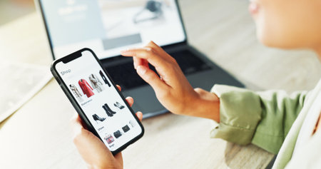 Fashion, hands and phone screen with designer at desk in office for browsing or scrolling. Catalog,...