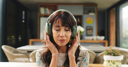 Break, headphones and meditation with woman on sofa in living room of home for stress relief. Audio...