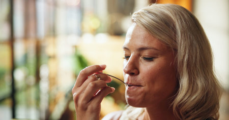 Home, woman and eating with spoon for breakfast, delicious meal and flavor satisfaction for health....