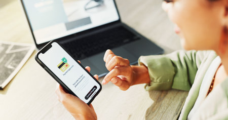Online shopping, laptop or hands with phone screen for payment, digital purchase or successful transaction. Ecommerce, banking approval or woman with fintech from high angle or customer experienceの写真素材