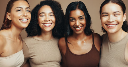 Women, portrait and diversity in studio for dermatology, solidarity and bonding together with hug and unity. Friends, support and inclusion on brown background for love, community and natural beautyの写真素材