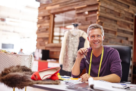 Fashion designer, man or happy with portrait in workshop for creativity, design process or planning. Clothing startup, mature person or smile with glasses in office for production oversight or tailorの写真素材