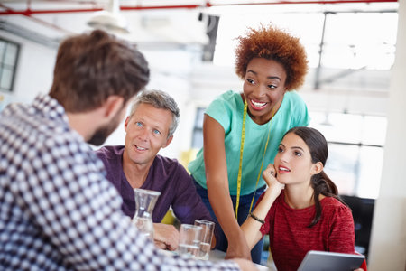 Fashion designer, team and meeting with discussion in office for creative ideas, feedback or...