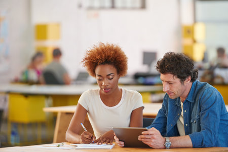 Creative, tablet and people in office for meeting with article ideas, submission and planning. Magazine agency, team and workers with tech, writing notes and research for news, feedback and editingの写真素材