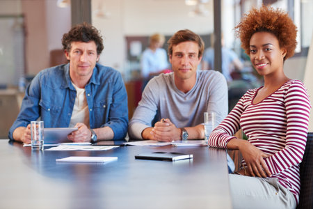 Creative portrait, people and meeting in office for story planning, news review or topic coverage. Newsroom, team and journalist with smile in brainstorming session for task delegation and feedbackの写真素材