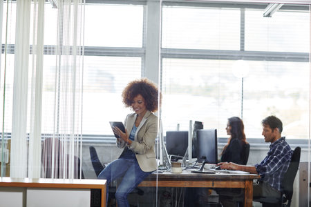 Creative agency, woman or reading with tablet in startup, market research or check guidelines for publication. Coworking, editing tech or copywriting manager with staff, review advert or brand voiceの写真素材