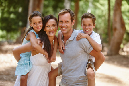 Portrait, piggy back or family in forest with smile, connection or bonding on summer break. Happy, parent or child in nature with care, healthy relationship or childhood development in spring getawayの写真素材