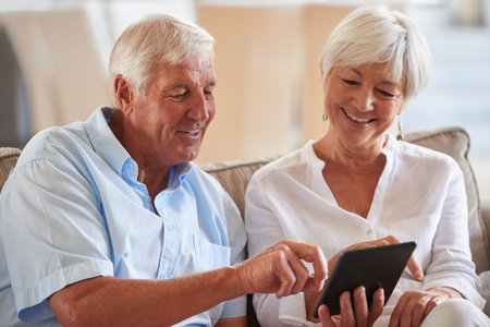 Streaming, smile or old couple on couch with tablet, scroll or search for digital entertainment in...