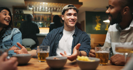 Conversation, friends and people in pub, beer and bonding together with reunion. Beverage, men and woman in restaurant, event and laughing with joke, alcohol and social gathering with happinessの写真素材