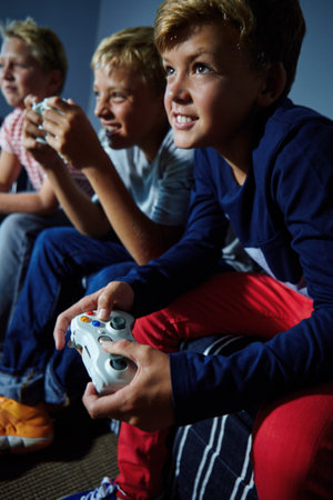Video games, friends and teens on sofa in home for playing, competition and online entertainment....