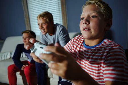 Children, playing and video game with boy on sofa in living room of home together for fun....