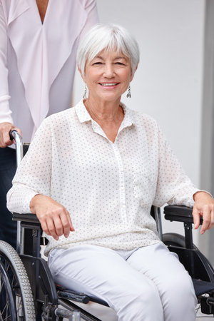 Portrait, smile or old woman outside with wheelchair, wellness or enjoyment at nursing home. Happy, retirement or senior person outdoor with mobility aid, fresh air or help with medical condition.の写真素材