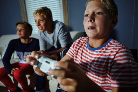 Children, concentration and video game with boy on sofa in living room of home together for fun....