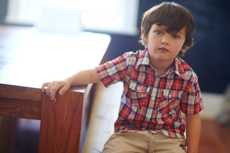 Portrait, child and boy relax at house for peace, calm morning and weekend break in home. Serious,...